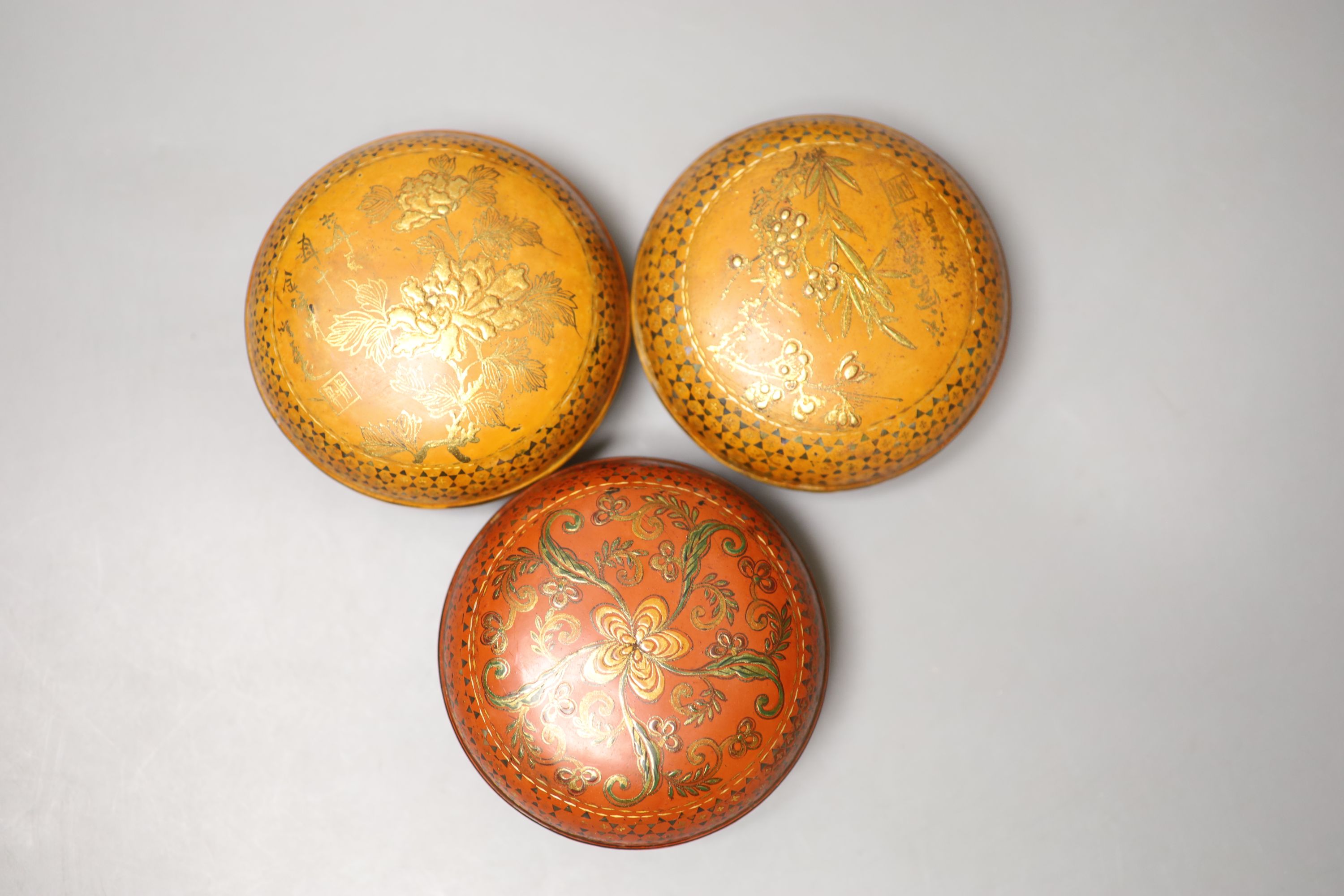 Three circular gilded lacquer boxes and a similar rectangular box